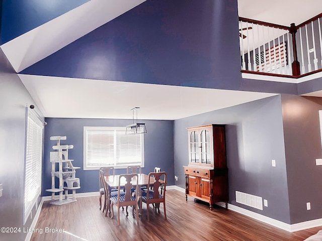 dining space with an inviting chandelier and hardwood / wood-style flooring