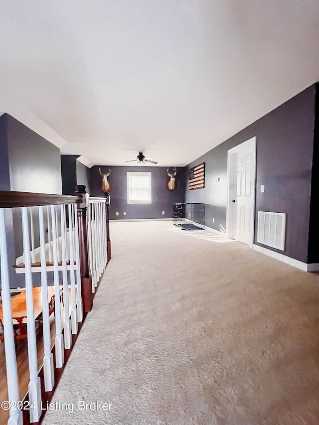 spare room featuring ceiling fan and carpet flooring