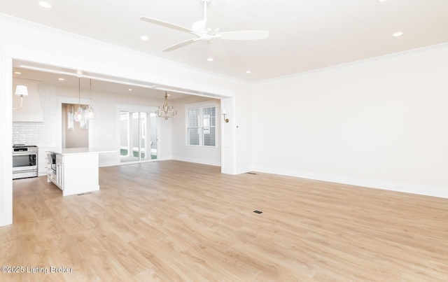 unfurnished living room with crown molding, ceiling fan with notable chandelier, and light hardwood / wood-style flooring