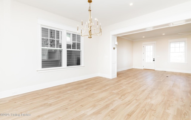 unfurnished room featuring light hardwood / wood-style floors and a notable chandelier