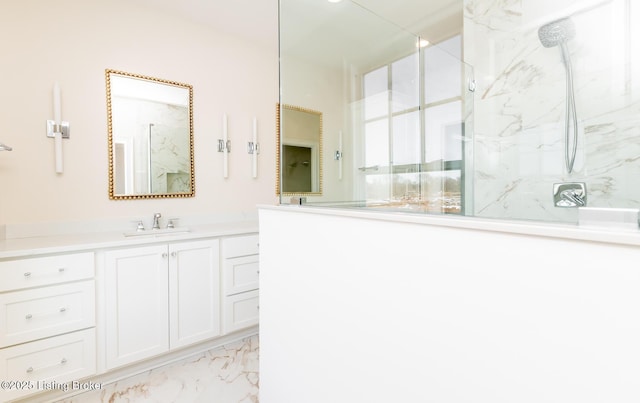 bathroom with walk in shower and vanity