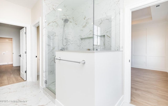 bathroom featuring walk in shower and a tray ceiling