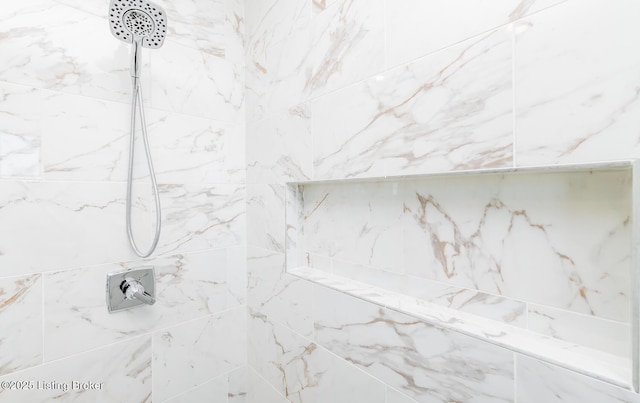 bathroom with a tile shower