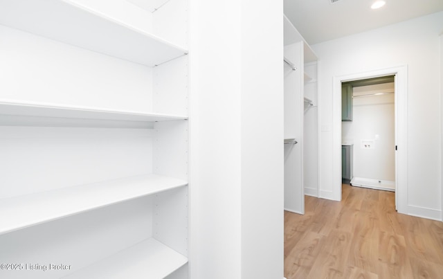 walk in closet featuring light hardwood / wood-style floors