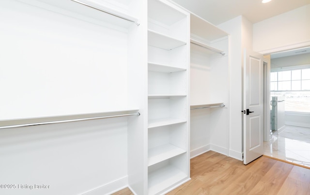 walk in closet featuring light hardwood / wood-style flooring