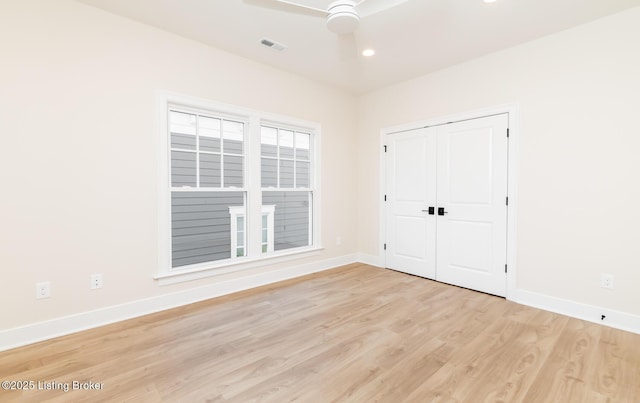 unfurnished bedroom featuring ceiling fan, a closet, and light hardwood / wood-style flooring