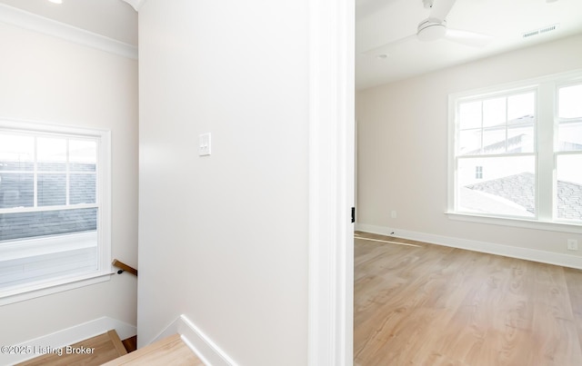 interior space featuring ornamental molding and light hardwood / wood-style floors