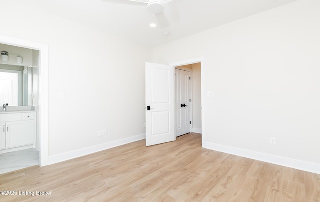 interior space with sink, ceiling fan, and light hardwood / wood-style flooring