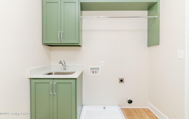 clothes washing area with cabinets, hookup for a washing machine, sink, and hookup for an electric dryer