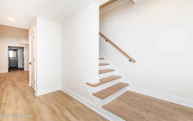 stairway featuring hardwood / wood-style flooring