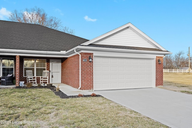 ranch-style house featuring a garage, a front lawn, and a porch