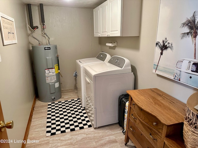 laundry room featuring cabinets, water heater, and washing machine and clothes dryer