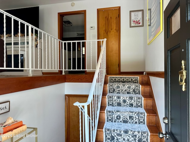 stairs with hardwood / wood-style flooring