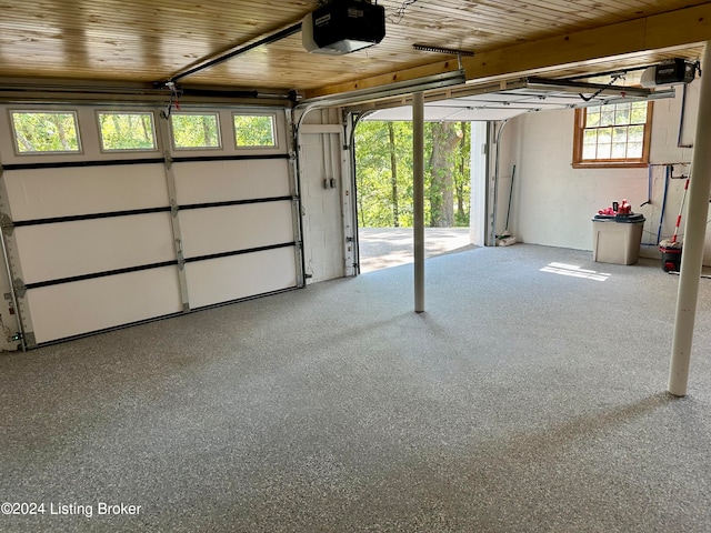 garage featuring wooden ceiling and a garage door opener