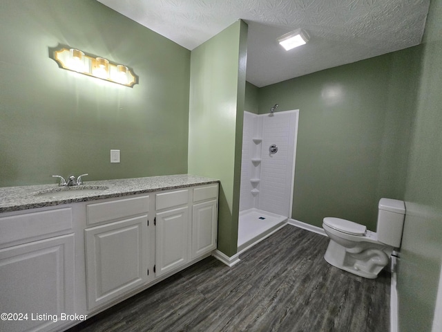 bathroom with a shower, wood-type flooring, and toilet