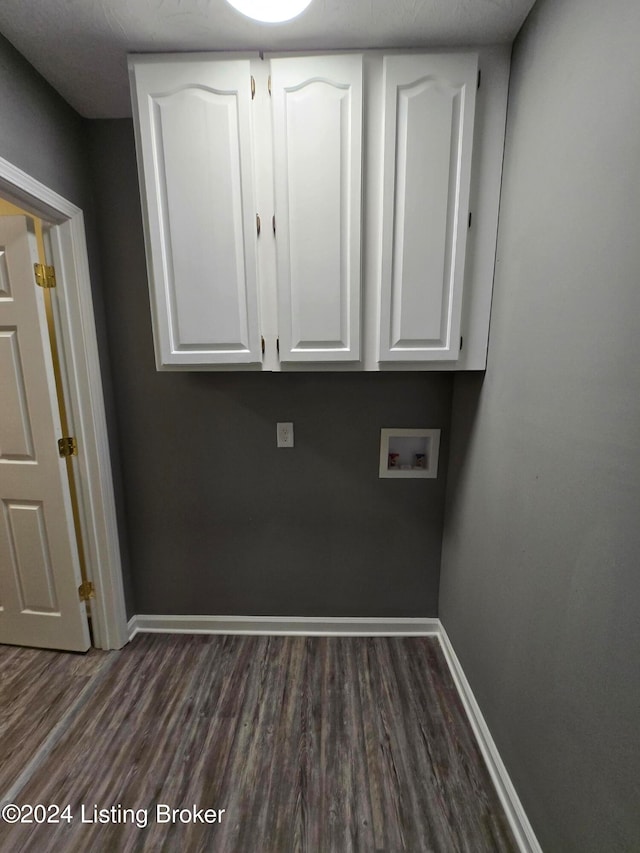 laundry area featuring cabinets, dark wood-type flooring, and hookup for a washing machine