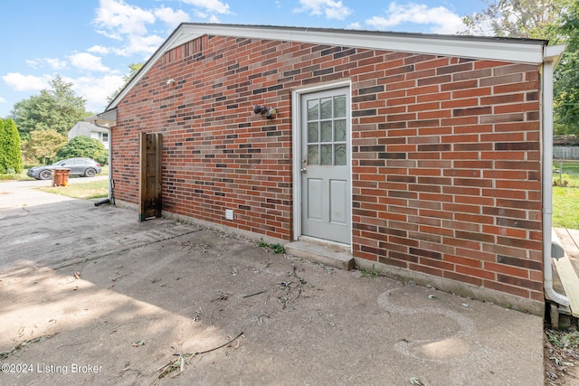 entrance to property featuring a patio area