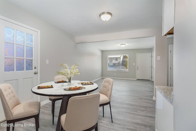 dining space featuring light wood-type flooring