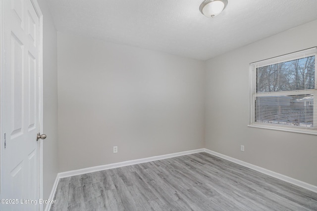 empty room with light hardwood / wood-style floors