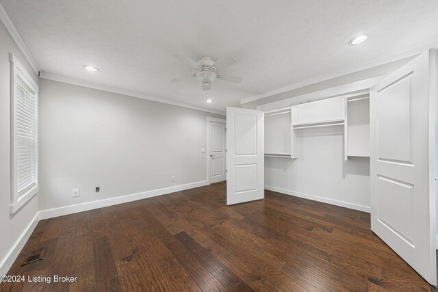 unfurnished bedroom with ceiling fan, a textured ceiling, a closet, crown molding, and dark hardwood / wood-style flooring