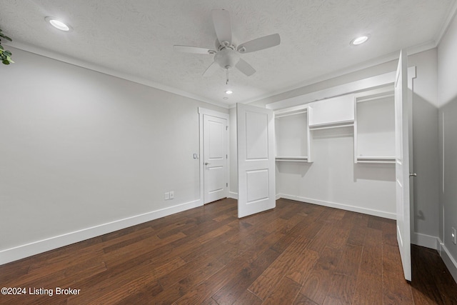 unfurnished bedroom featuring a textured ceiling, dark hardwood / wood-style flooring, ceiling fan, and a closet