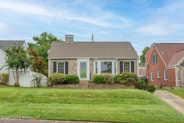 bungalow-style home featuring a front yard