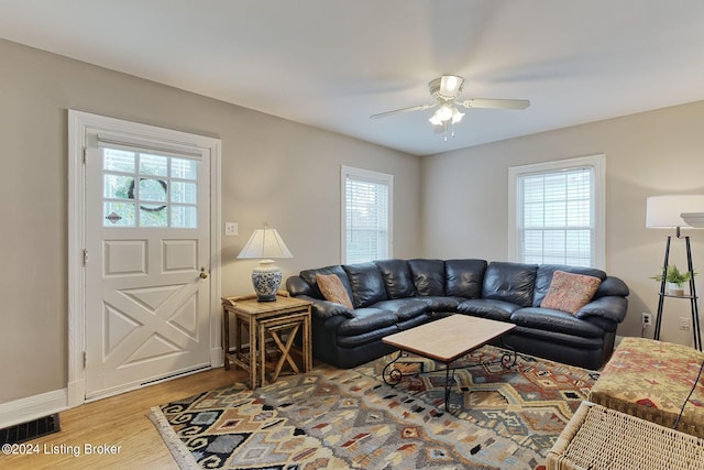 living room with hardwood / wood-style flooring, ceiling fan, and plenty of natural light