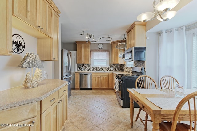 kitchen with light brown cabinets, light tile patterned floors, tasteful backsplash, stainless steel appliances, and an inviting chandelier