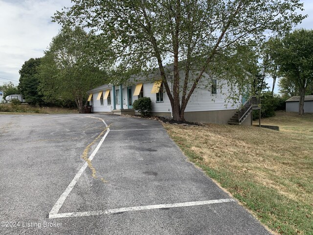 view of front of property with a garage and a front lawn