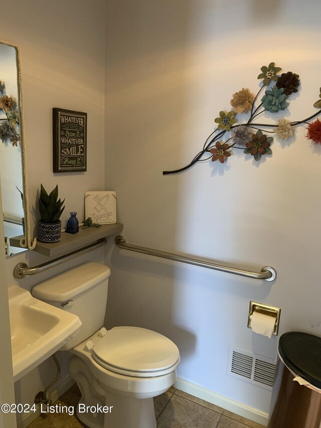 bathroom with tile patterned flooring and toilet