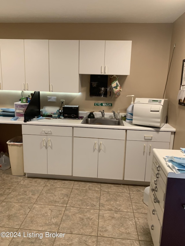 8910 Main St, Campbellsburg, KY 40011 - kitchen with white cabinetry, light countertops, and a sink