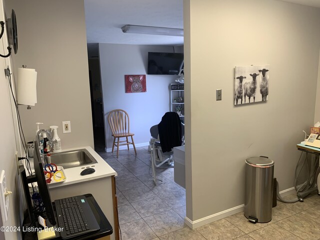 interior space featuring sink and light tile patterned floors