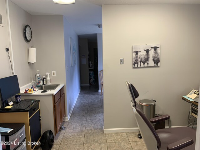 office space with light tile patterned floors and sink