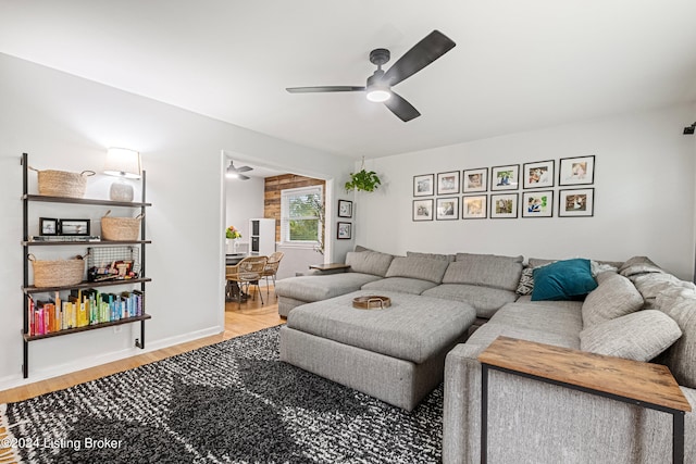 living room featuring hardwood / wood-style floors and ceiling fan