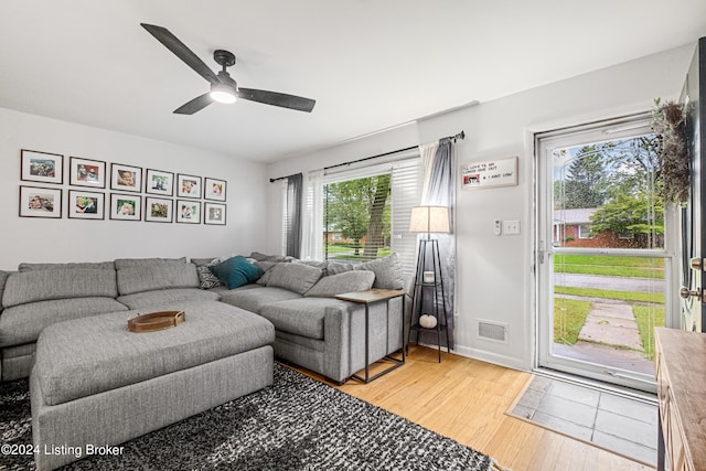 living room with ceiling fan, hardwood / wood-style flooring, and a wealth of natural light