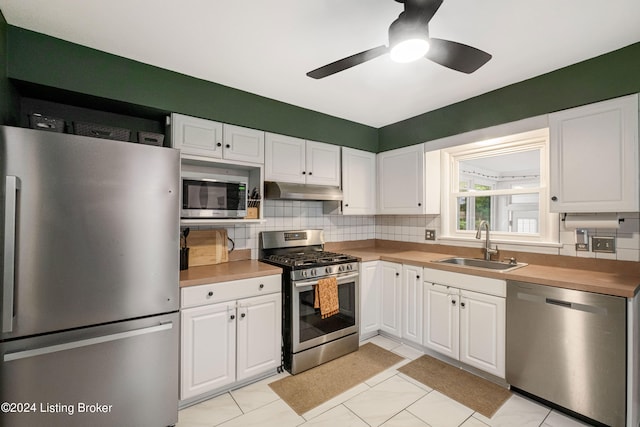 kitchen with ceiling fan, appliances with stainless steel finishes, and white cabinetry