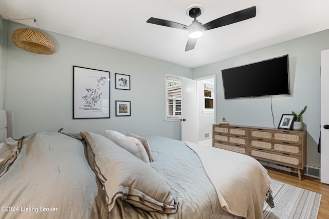 bedroom with ceiling fan and hardwood / wood-style flooring