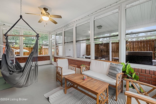 sunroom / solarium featuring a wealth of natural light and ceiling fan