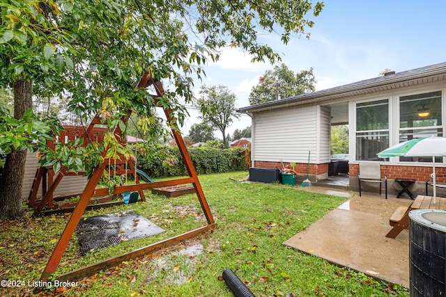 view of yard featuring a playground and a patio area