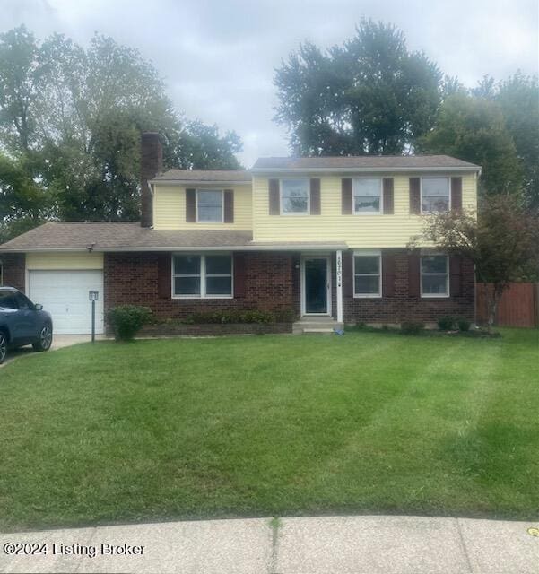 view of front of home featuring a garage and a front lawn