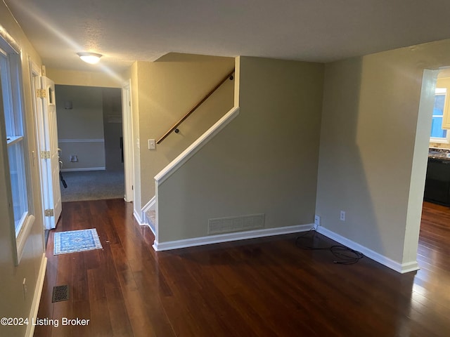 empty room with dark wood-type flooring