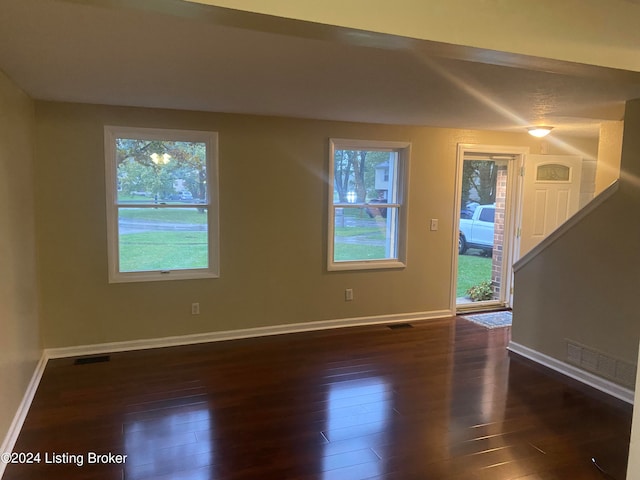 unfurnished room featuring dark hardwood / wood-style floors