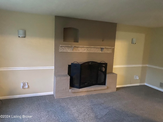 unfurnished living room with a brick fireplace and carpet floors