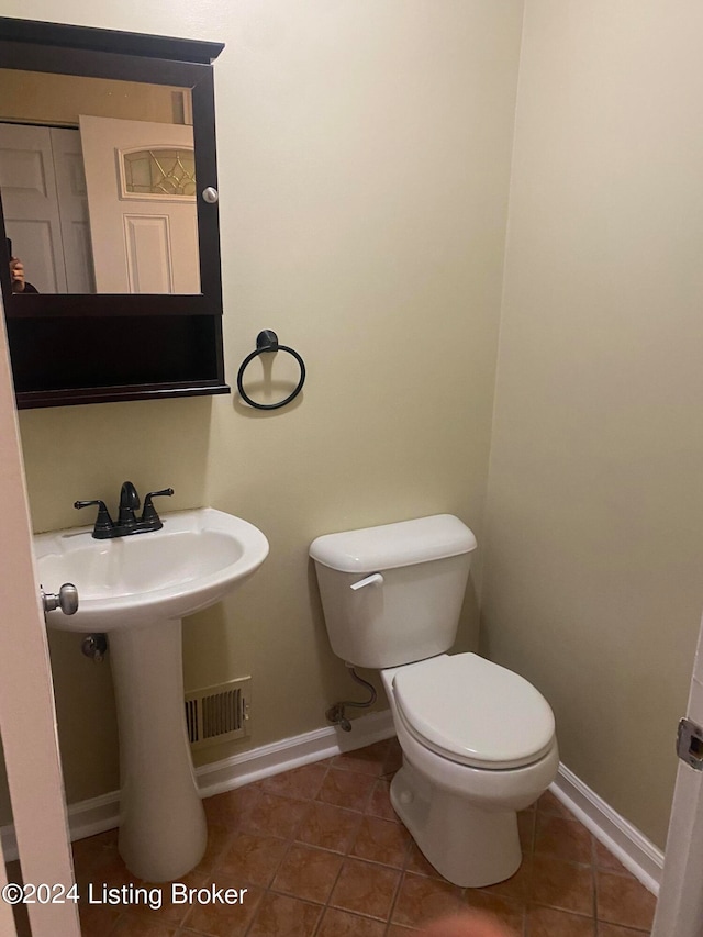 bathroom featuring tile patterned flooring and toilet