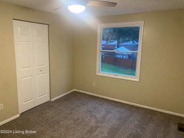 carpeted empty room with ceiling fan