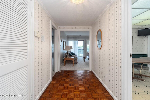 corridor with ornamental molding and dark parquet floors