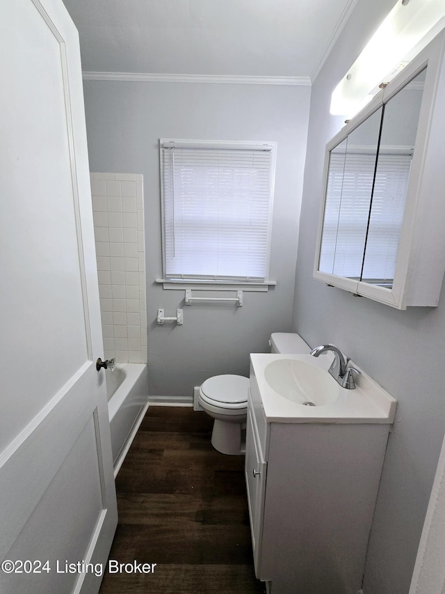 bathroom with a tub to relax in, crown molding, hardwood / wood-style floors, and vanity