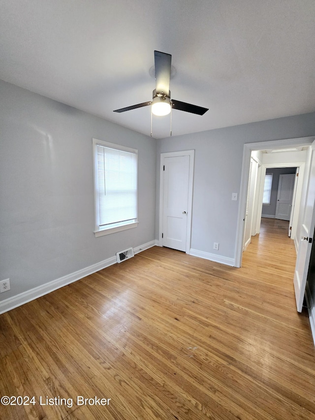 unfurnished bedroom featuring ceiling fan and light wood-type flooring