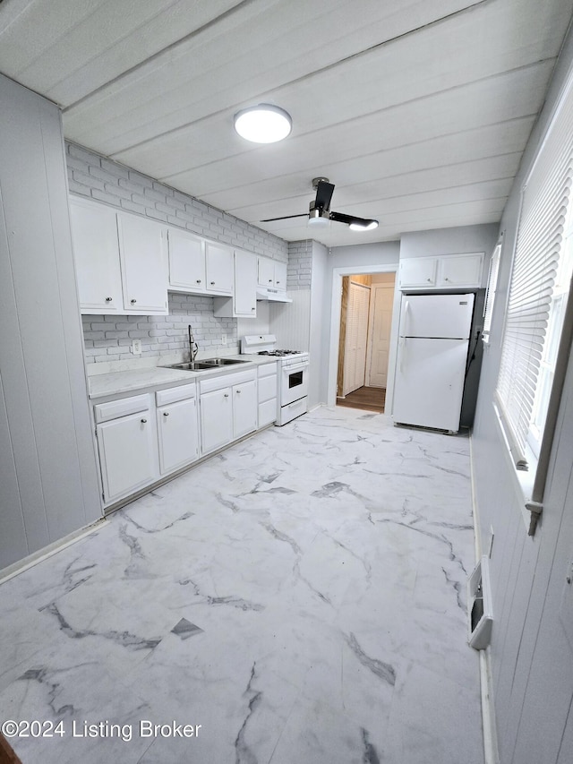 kitchen with white appliances, sink, ceiling fan, tasteful backsplash, and white cabinetry