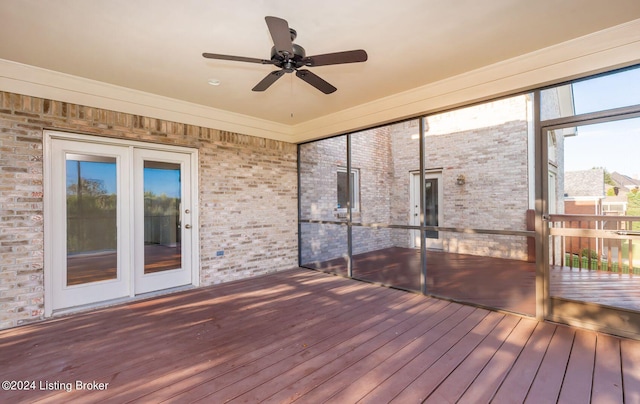 unfurnished sunroom with ceiling fan